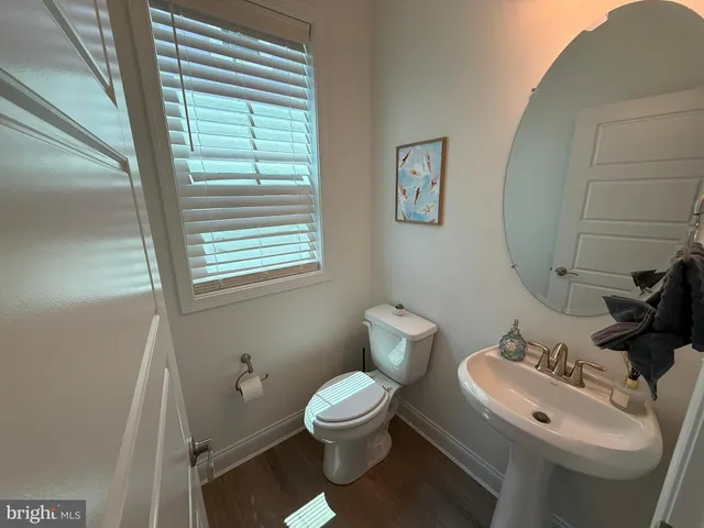 a bathroom with a toilet a sink and a mirror
