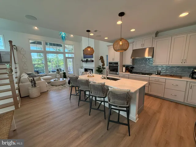 a large kitchen with a table and chairs