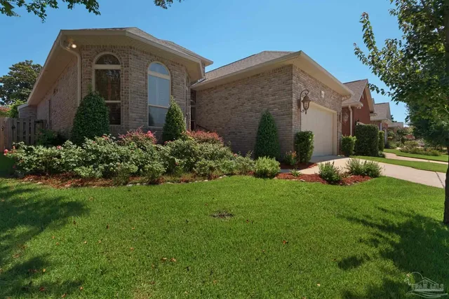 a front view of a house with garden