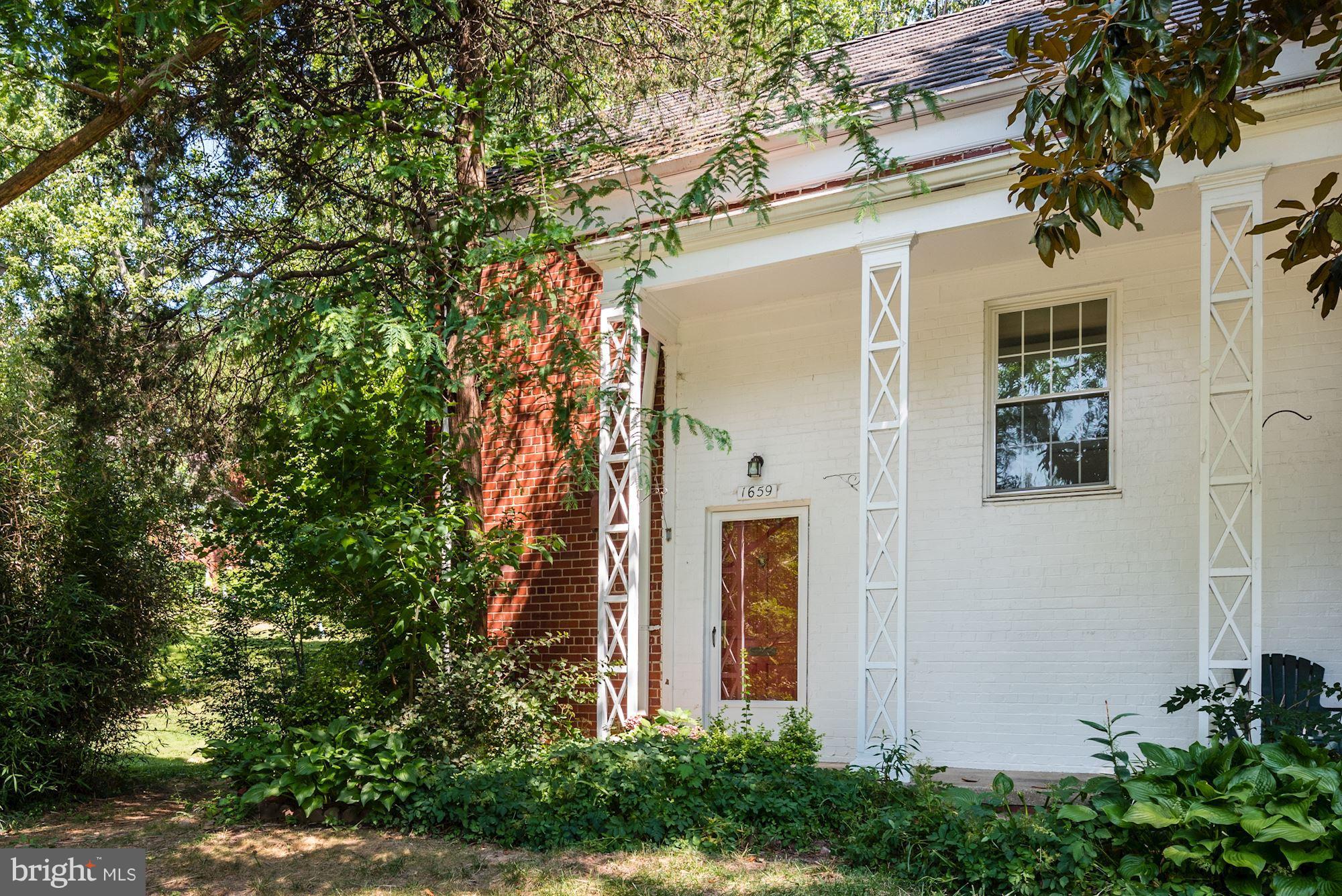 a front view of a house with trees