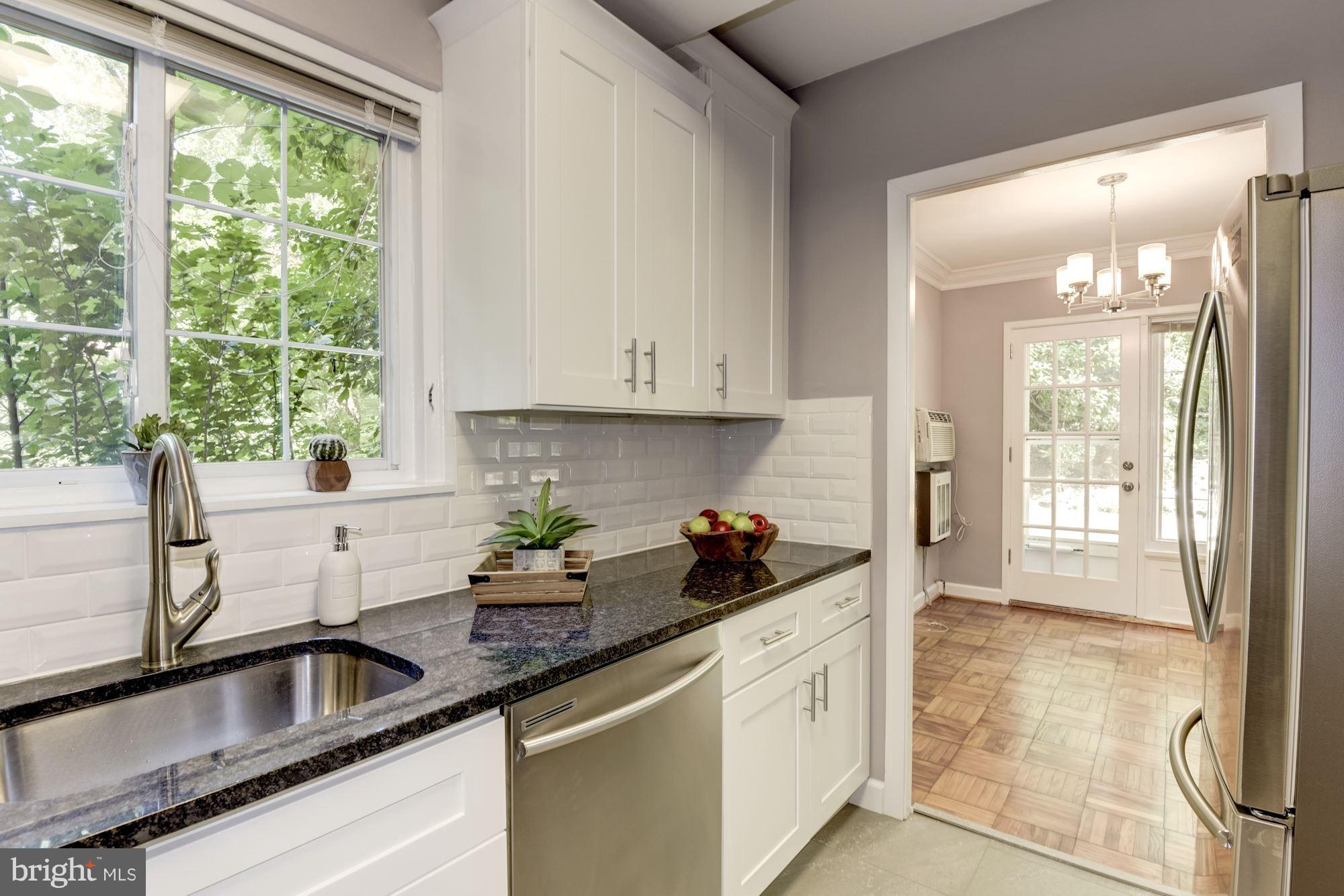 1659 Preston Road Alexandria, VA 22302 - Photo 11 of 26 a kitchen with sink a window and cabinets