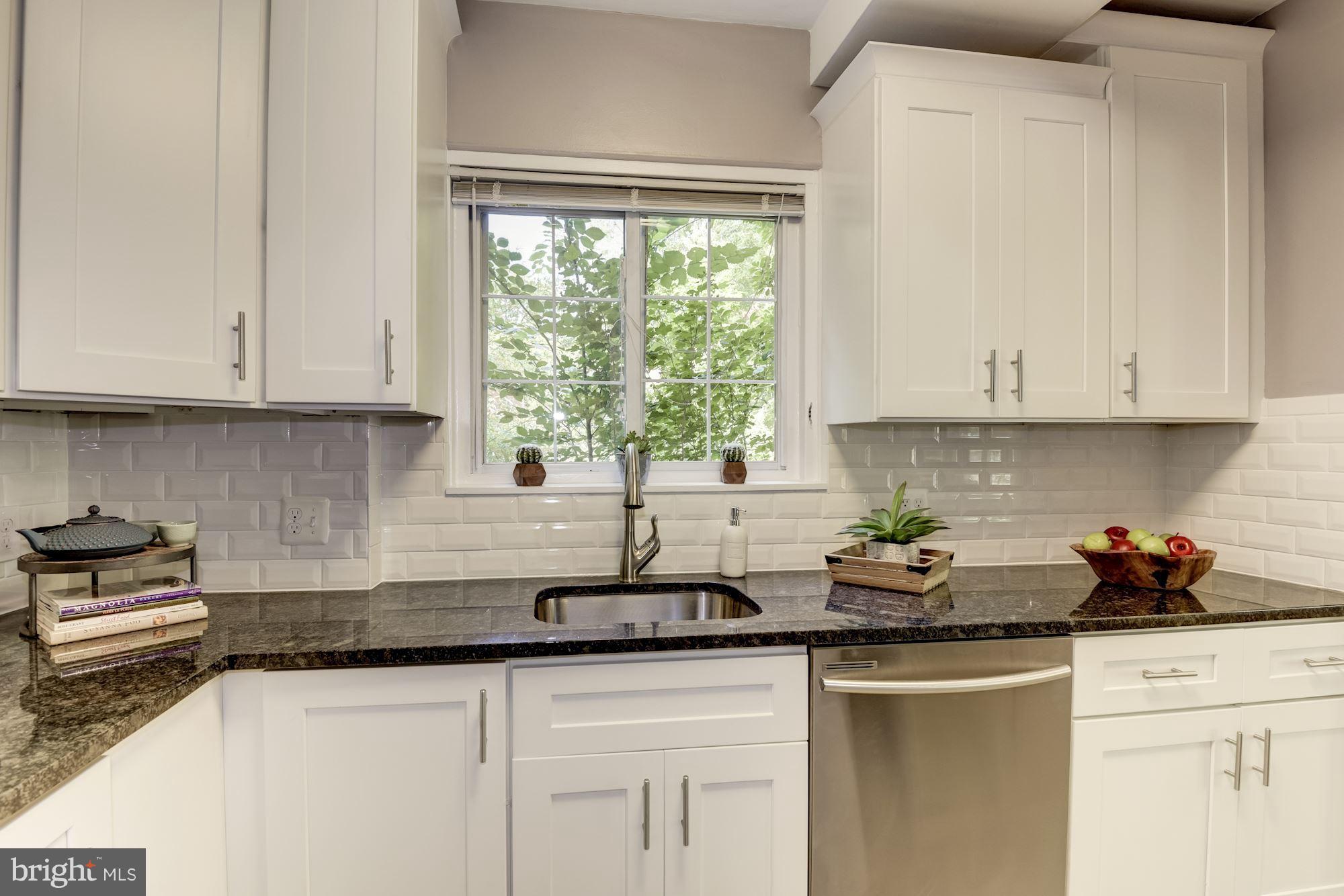 1659 Preston Road Alexandria, VA 22302 - Photo 12 of 26 a kitchen with stainless steel appliances granite countertop white cabinets sink and window