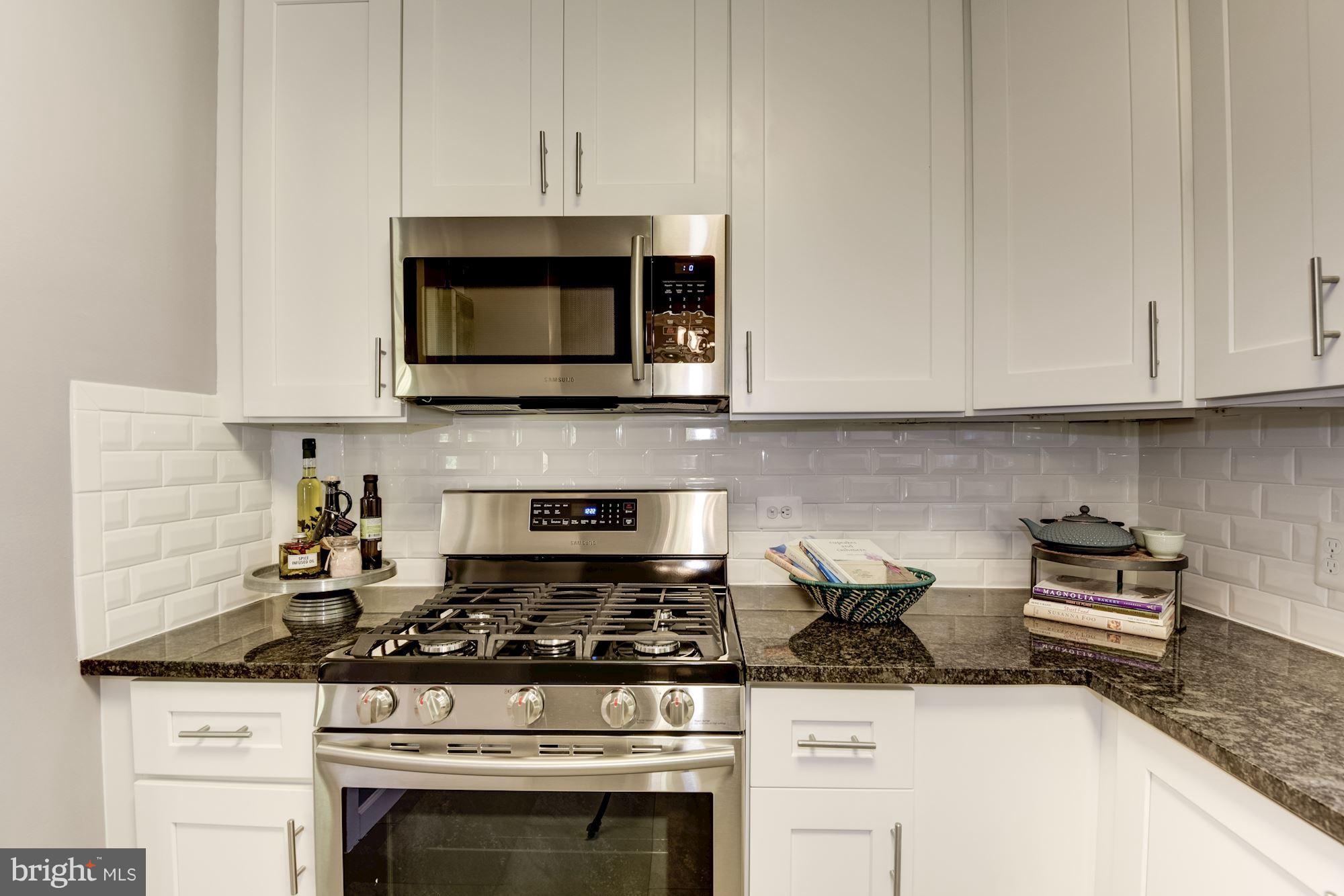 1659 Preston Road Alexandria, VA 22302 - Photo 3 of 26 a kitchen with granite countertop a stove and a microwave