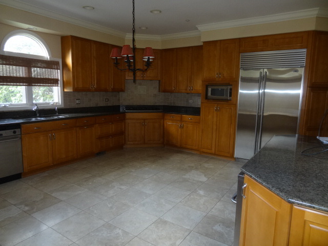 8 Ridge Road Highland Park, IL 60035 - Photo 3 of 20 a kitchen with stainless steel appliances granite countertop a sink and a refrigerator
