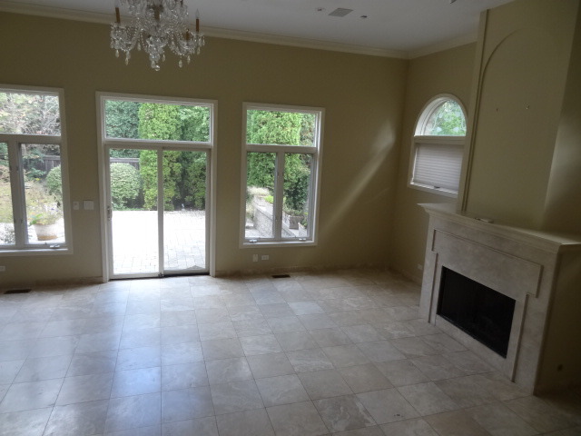 8 Ridge Road Highland Park, IL 60035 - Photo 6 of 20 an empty room with windows chandelier and fireplace