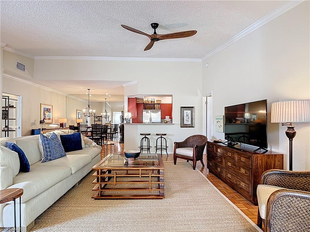 106 Siena Way, Unit 1508 Naples, FL 34119 - Photo 11 of 47 a living room with furniture and a flat screen tv