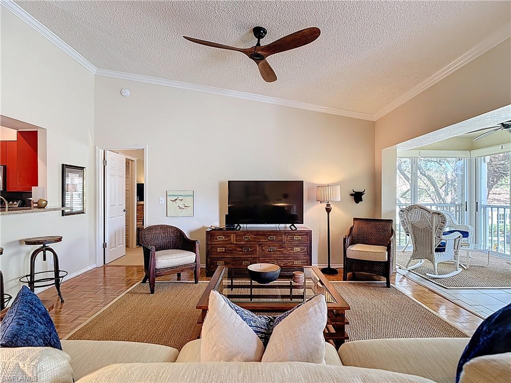 106 Siena Way, Unit 1508 Naples, FL 34119 - Photo 13 of 47 a living room with furniture and a flat screen tv