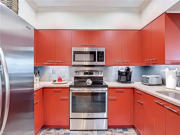 a kitchen with stainless steel appliances granite countertop a stove top oven a sink and dishwasher