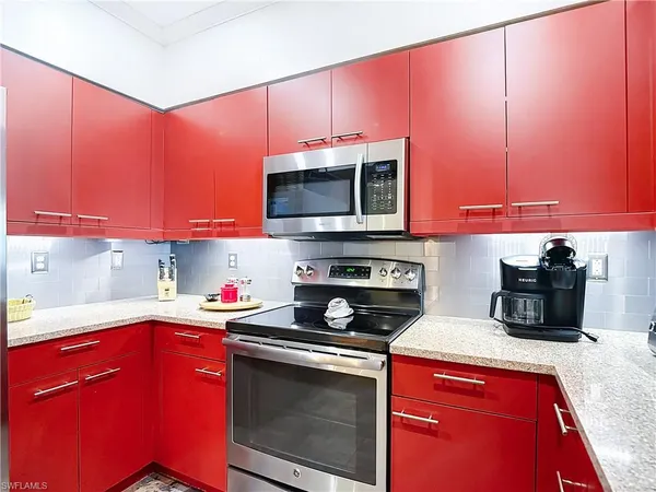 a kitchen with stainless steel appliances a microwave sink and cabinets