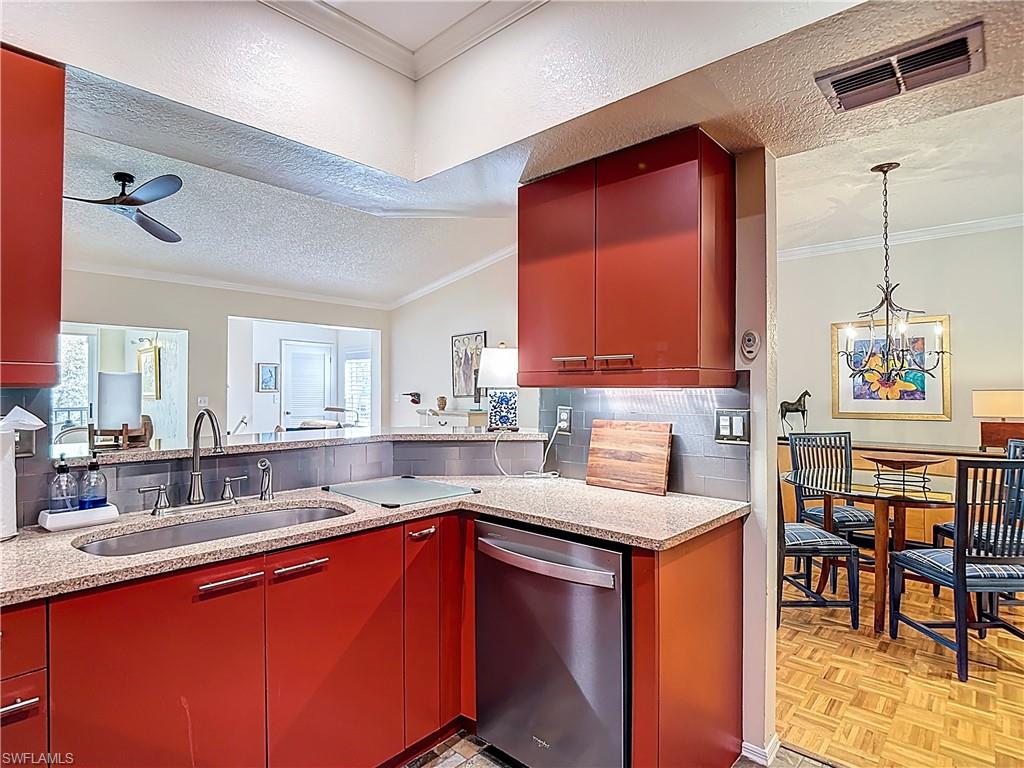 106 Siena Way, Unit 1508 Naples, FL 34119 - Photo 20 of 47 a kitchen with stainless steel appliances granite countertop sink stove top oven and cabinets