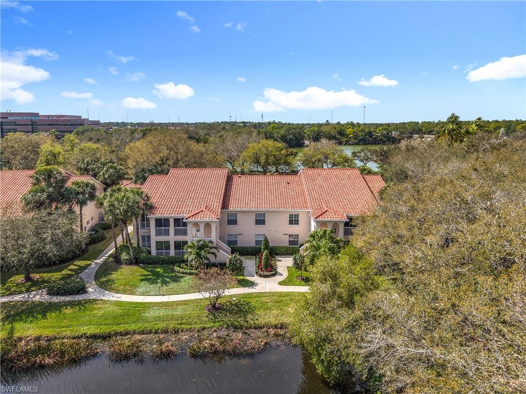 106 Siena Way, Unit 1508 Naples, FL 34119 - Photo 2 of 47 a view of a house with a yard and lake view
