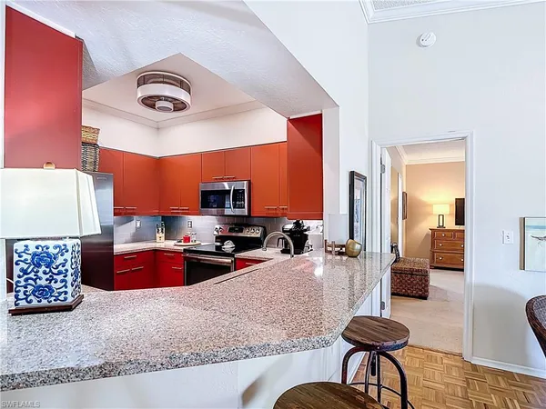 a kitchen with stainless steel appliances granite countertop a stove and a refrigerator