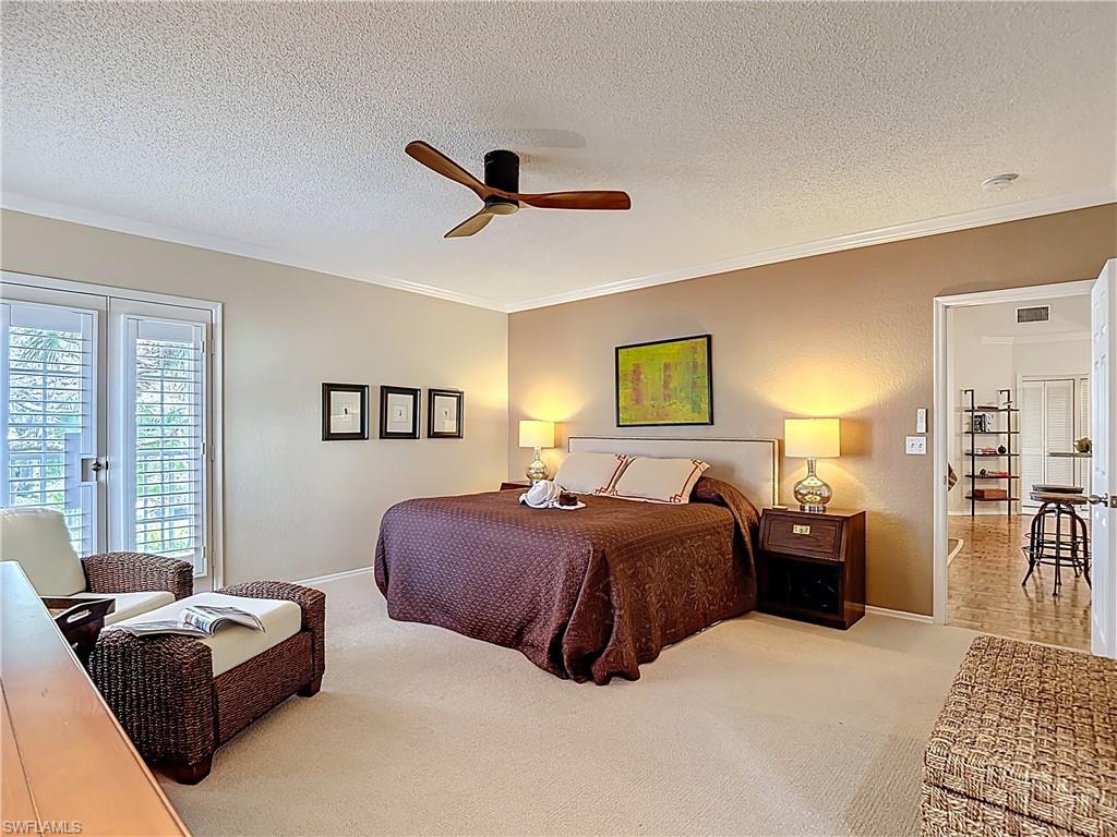 106 Siena Way, Unit 1508 Naples, FL 34119 - Photo 23 of 47 a bedroom with a bed couch and a window