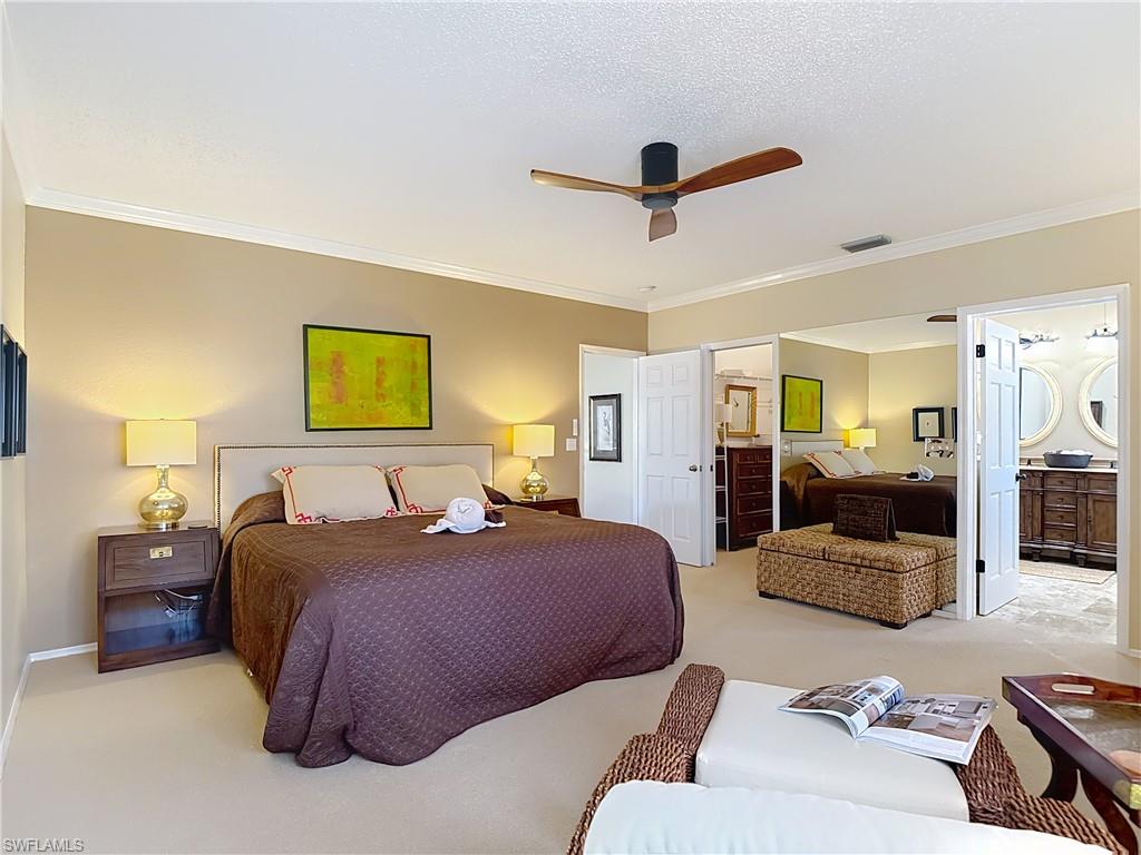 106 Siena Way, Unit 1508 Naples, FL 34119 - Photo 24 of 47 a bedroom with a bed couch and window