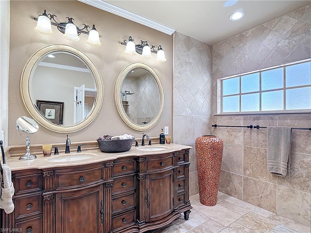 106 Siena Way, Unit 1508 Naples, FL 34119 - Photo 27 of 47 a bathroom with a sink mirror and vanity