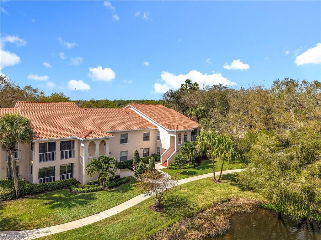 106 Siena Way, Unit 1508 Naples, FL 34119 - Photo 3 of 47 a front view of a house with a yard