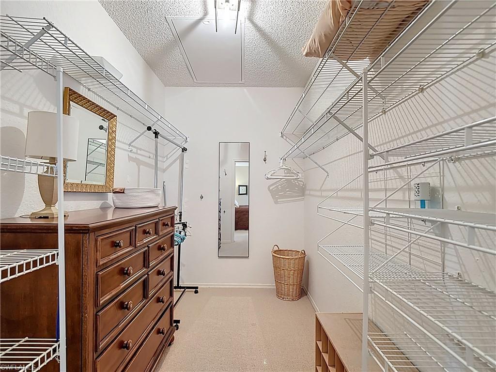 106 Siena Way, Unit 1508 Naples, FL 34119 - Photo 31 of 47 a kitchen with stainless steel appliances kitchen island granite countertop a stove and a refrigerator