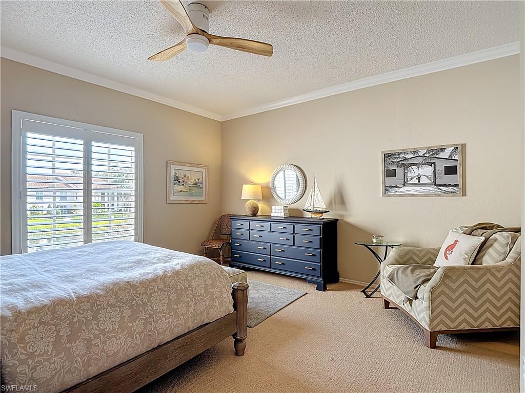 106 Siena Way, Unit 1508 Naples, FL 34119 - Photo 32 of 47 a bedroom with a bed and window