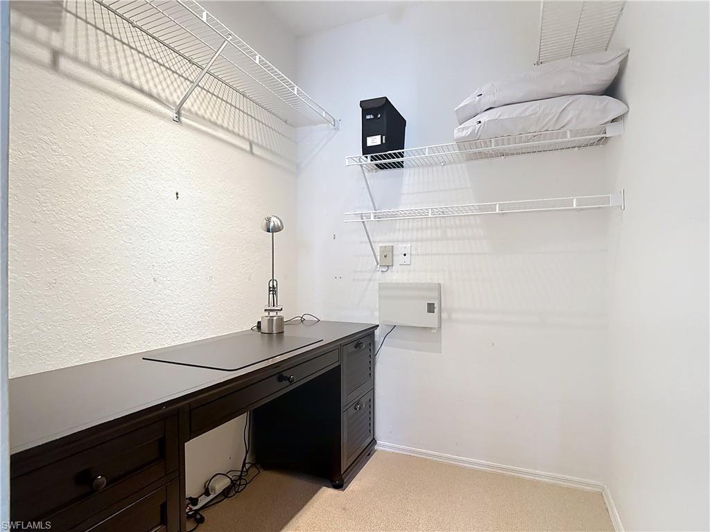 106 Siena Way, Unit 1508 Naples, FL 34119 - Photo 35 of 47 a room with a sink and cabinets