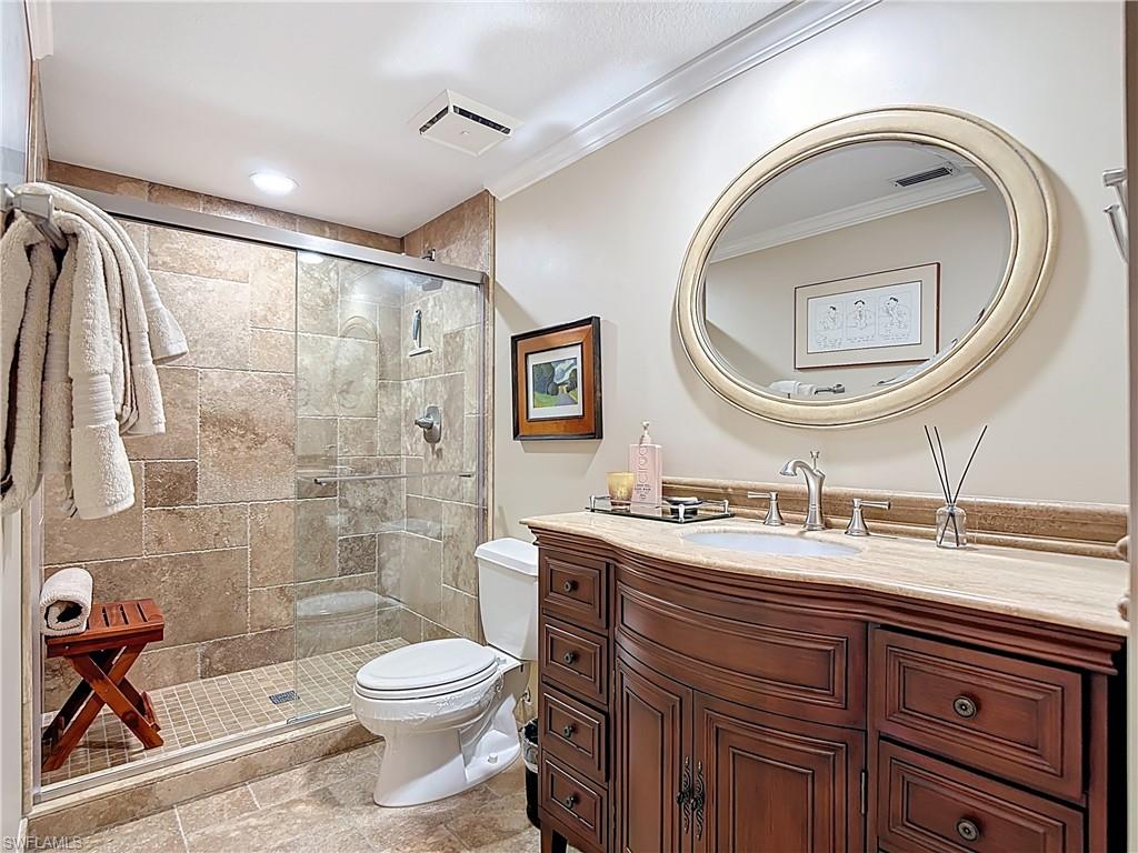 106 Siena Way, Unit 1508 Naples, FL 34119 - Photo 37 of 47 a bathroom with a toilet a sink and a mirror