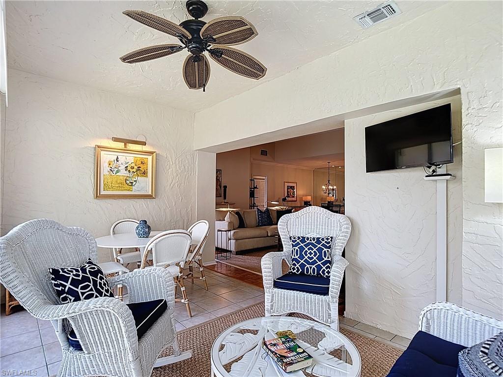 106 Siena Way, Unit 1508 Naples, FL 34119 - Photo 42 of 47 a living room with furniture a flat screen tv and a window