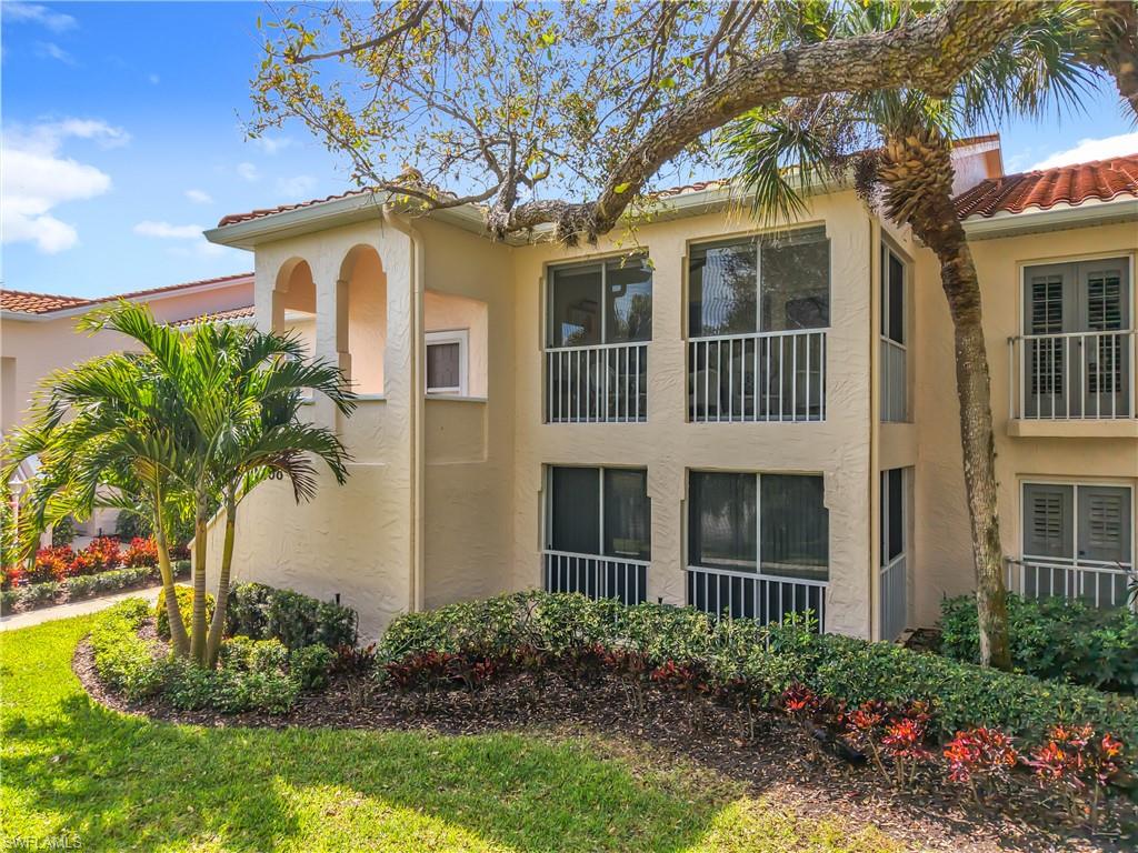 106 Siena Way, Unit 1508 Naples, FL 34119 - Photo 45 of 47 a view of a house with a yard and plants