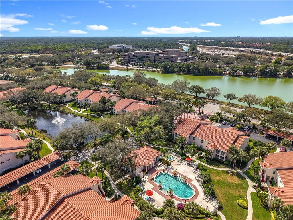 106 Siena Way, Unit 1508 Naples, FL 34119 - Photo 46 of 47 an aerial view of residential houses with outdoor space and lake view