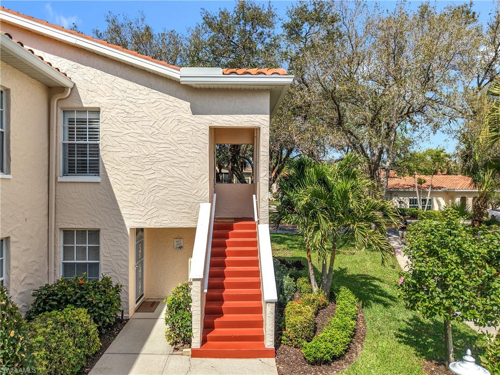 106 Siena Way, Unit 1508 Naples, FL 34119 - Photo 5 of 47 a front view of a house with a yard
