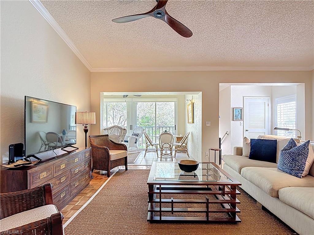 106 Siena Way, Unit 1508 Naples, FL 34119 - Photo 9 of 47 a living room with furniture and a flat screen tv