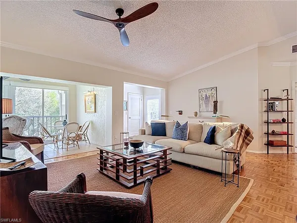 a living room with furniture a ceiling fan and a window