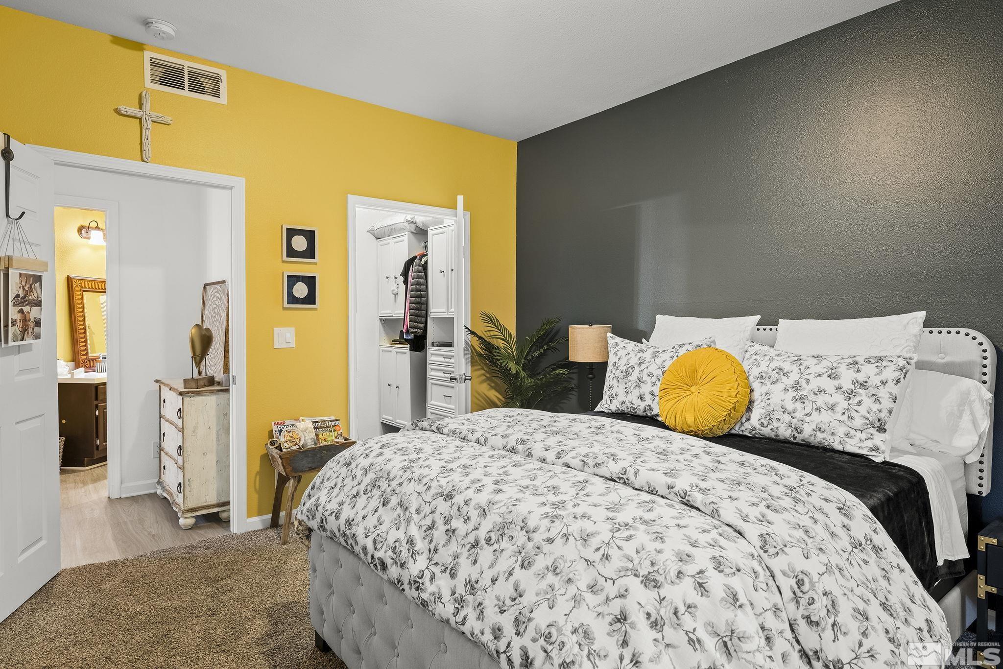 900 South Meadows Parkway, Unit 1713 Reno, NV 89521 - Photo 11 of 20 a bedroom with a bed and wooden floor