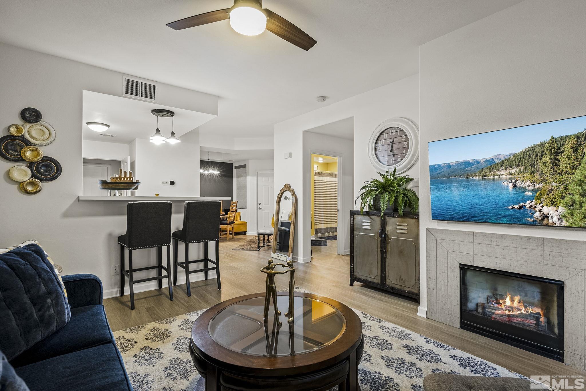 900 South Meadows Parkway, Unit 1713 Reno, NV 89521 - Photo 6 of 20 a living room with furniture and a fireplace