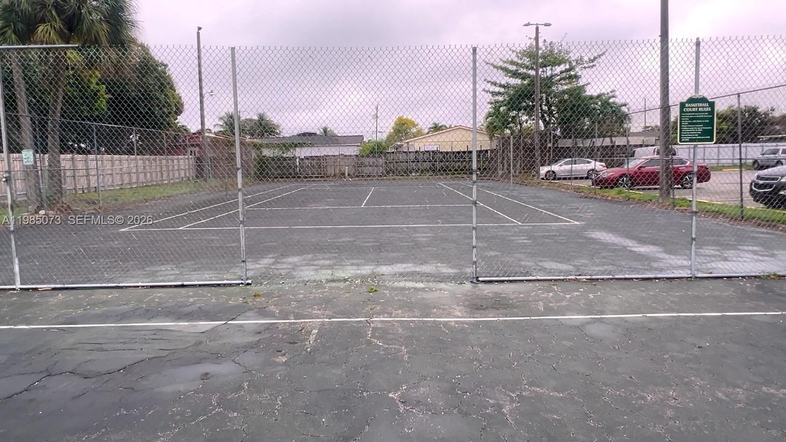 1900 West 68th Street, Unit D207 Hialeah, FL 33014 - Photo 15 of 33 a backyard of a house with a table and chairs
