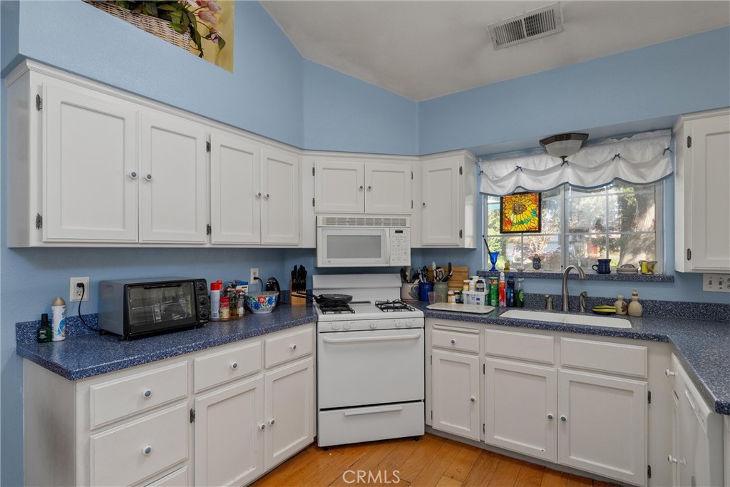 23 Carriage Lane Chico, CA 95926 - Photo 19 of 41 a kitchen with white cabinets and white appliances