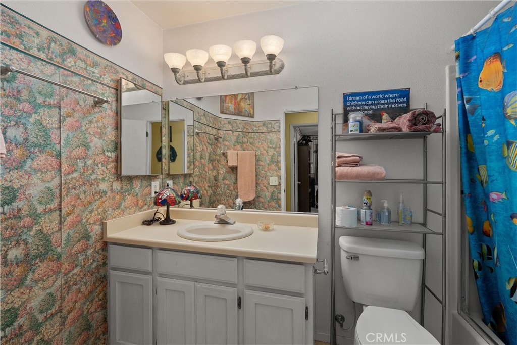 23 Carriage Lane Chico, CA 95926 - Photo 28 of 41 a bathroom with a sink a toilet and shower curtain