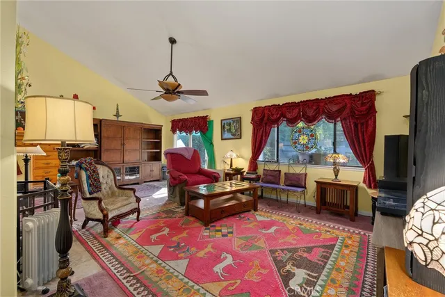 a living room with furniture a flat screen tv and a table