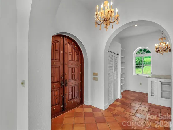 a view of a room with windows and chandelier