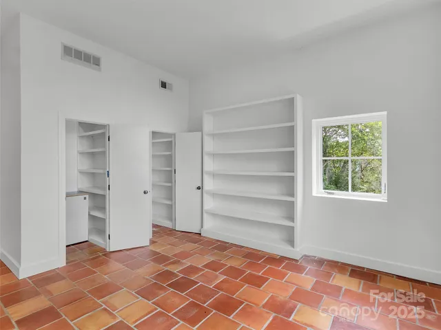 a view of an empty room and a window