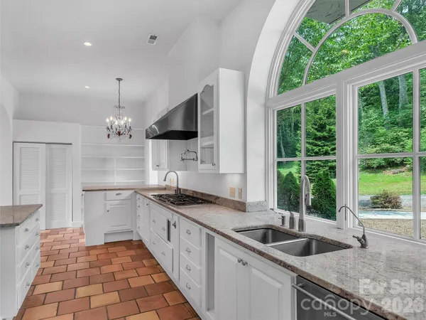 a living room with furniture a flat screen tv and a refrigerator