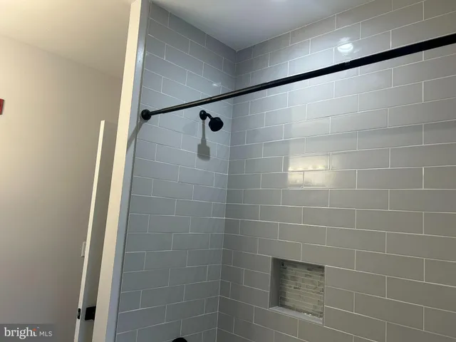 a bathroom with a shower and a glass door