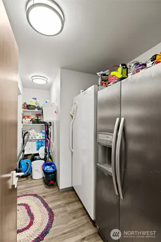 a kitchen with stainless steel appliances granite countertop a refrigerator and a sink
