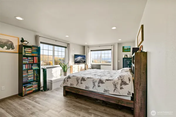 a bedroom with bed and wooden floor