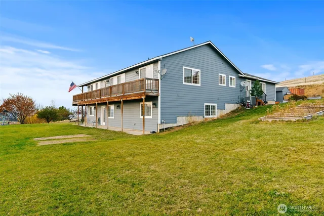 a front view of house with yard and trees in the background