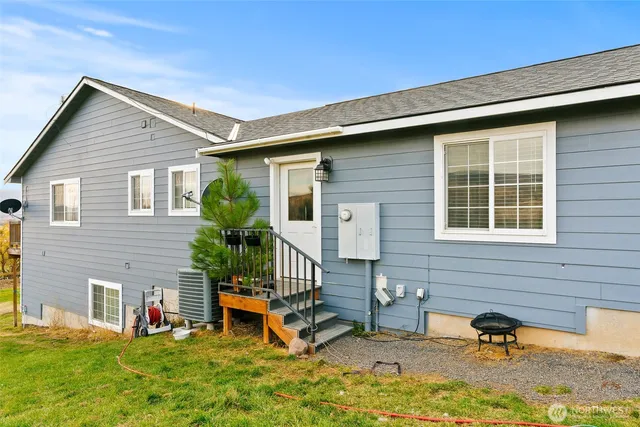 a view of a house with backyard porch and sitting area
