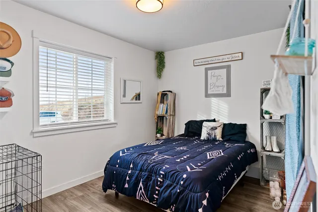 a bedroom with a large bed and a window