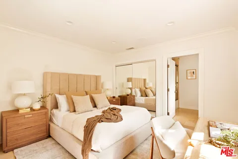 a bedroom with a bed and lamp