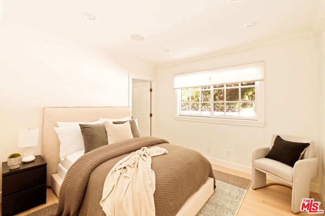 1132 Chantilly Road Los Angeles, CA 90077 - Photo 15 of 22 a bedroom with a bed and wooden floor