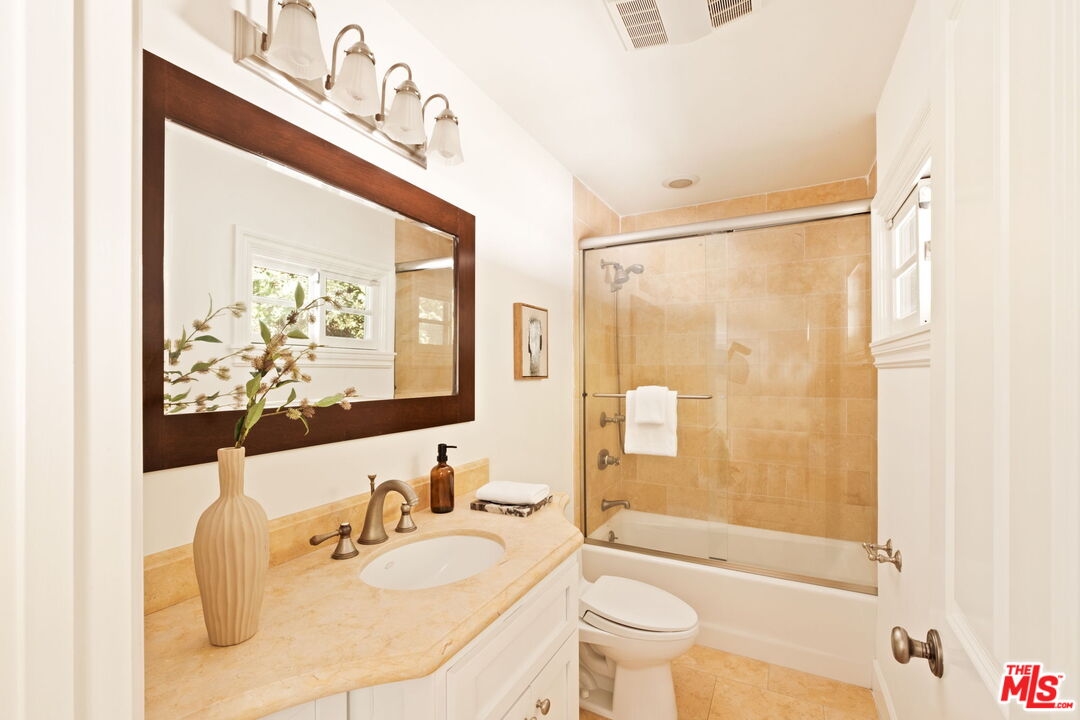 1132 Chantilly Road Los Angeles, CA 90077 - Photo 16 of 22 a bathroom with a sink mirror toilet and bathtub