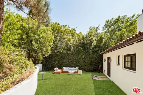 a couple of table and chairs in a yard