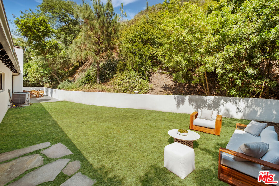 1132 Chantilly Road Los Angeles, CA 90077 - Photo 20 of 22 swimming pool with outdoor seating and green space